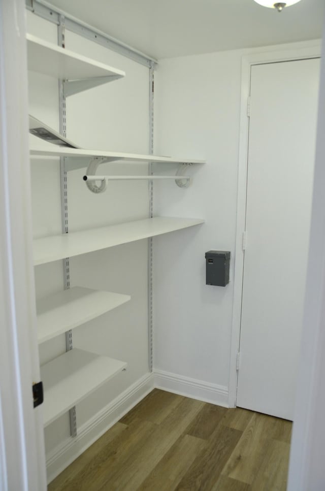 laundry area with hardwood / wood-style flooring