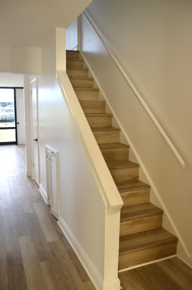 stairs with hardwood / wood-style floors