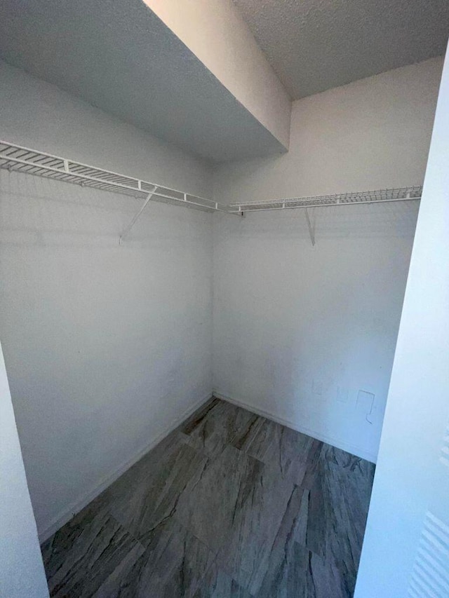 walk in closet featuring tile floors