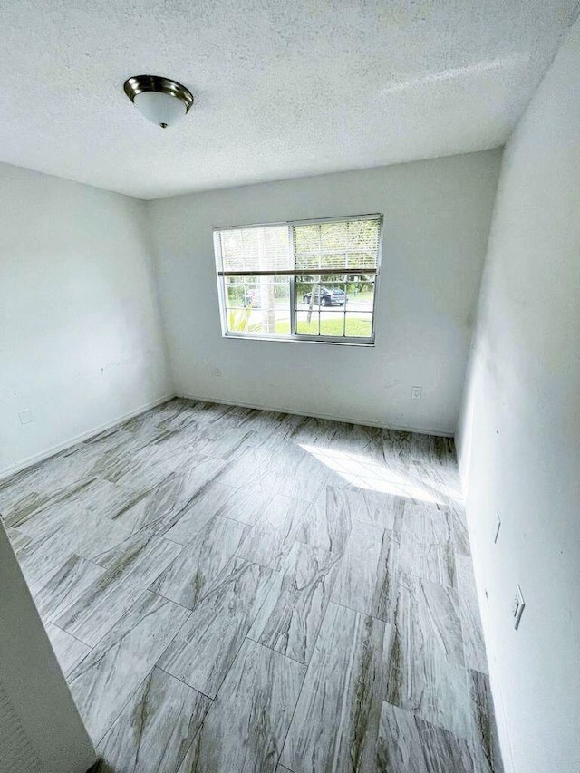 empty room with a textured ceiling