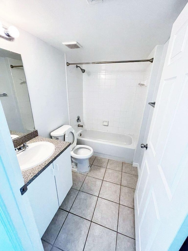 full bathroom featuring tiled shower / bath, tile flooring, oversized vanity, and toilet