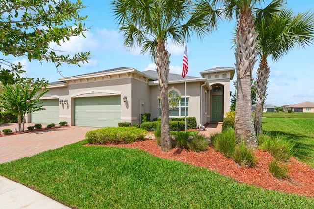 view of front of property with a front yard and a garage