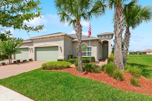 view of front of house featuring a garage and a front lawn