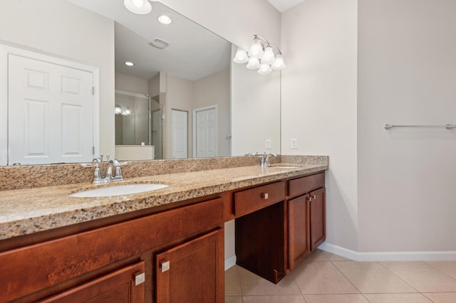 bathroom featuring tile patterned floors, a shower with door, and vanity