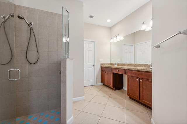 bathroom featuring vanity, tile patterned floors, and walk in shower