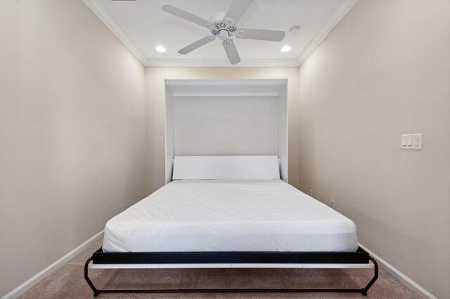 carpeted bedroom featuring ceiling fan and crown molding