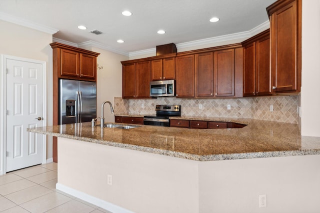 kitchen featuring kitchen peninsula, ornamental molding, stainless steel appliances, sink, and stone counters