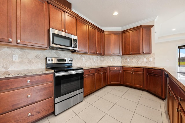 kitchen featuring light stone counters, light tile patterned floors, ornamental molding, and appliances with stainless steel finishes