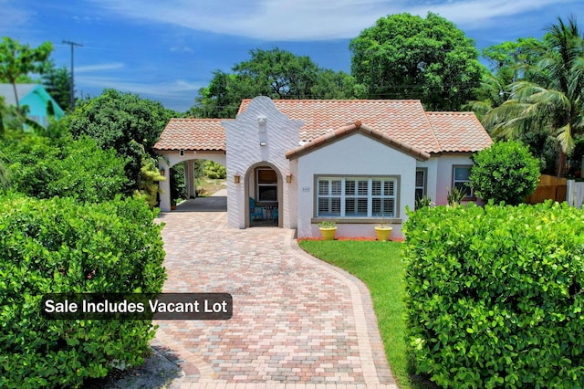 mediterranean / spanish-style home with a carport