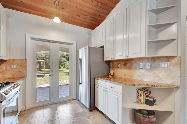 kitchen featuring light stone countertops, french doors, white cabinets, and white range