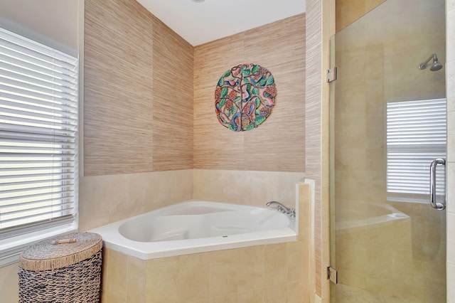 bathroom featuring separate shower and tub and tile walls