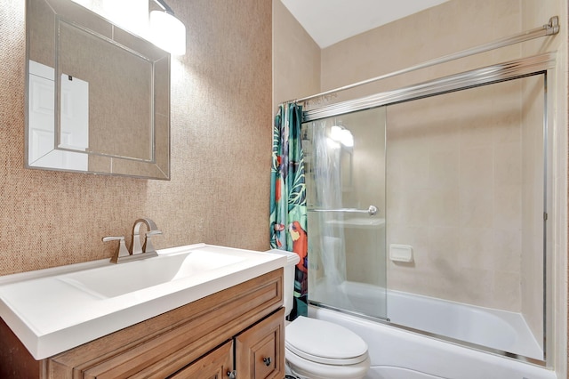 full bathroom with vanity, toilet, and bath / shower combo with glass door