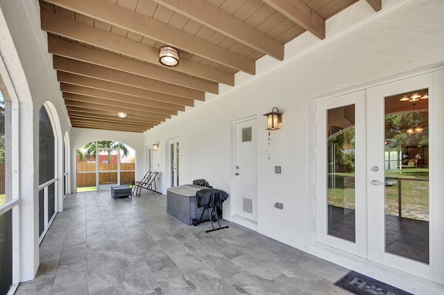 exterior space featuring beamed ceiling, wooden ceiling, and french doors