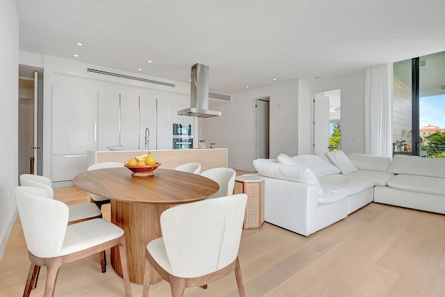 dining space featuring sink and light hardwood / wood-style floors