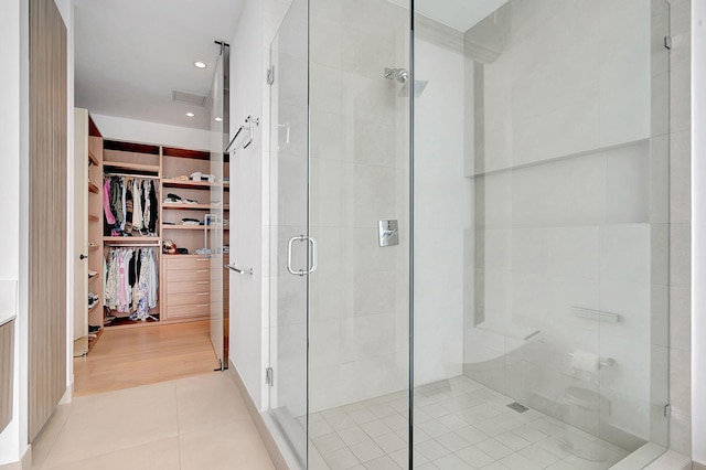 bathroom featuring hardwood / wood-style flooring and a shower with door