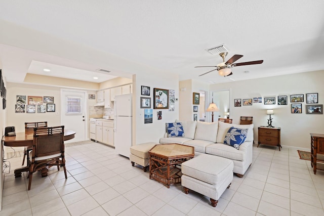 tiled living room with ceiling fan