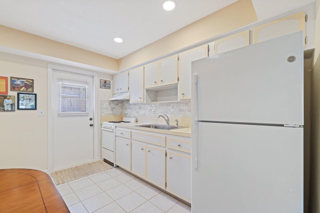 kitchen featuring white cabinetry, light tile patterned flooring, white appliances, and sink