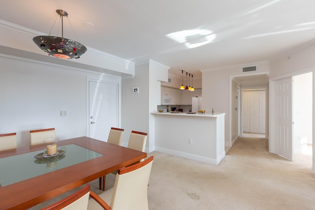 carpeted dining room with crown molding