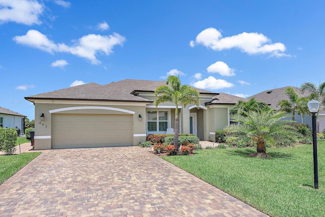 447 SW Vista Lake Dr, Port Saint Lucie, FL 34953 - view of front of property with a garage, decorative driveway, a front yard, and stucco siding