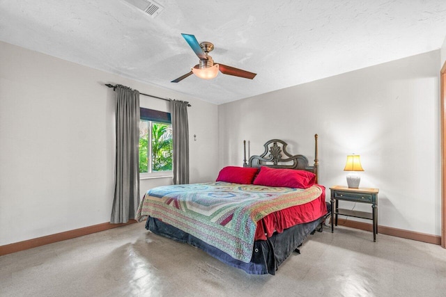 bedroom with ceiling fan, concrete flooring, and a textured ceiling