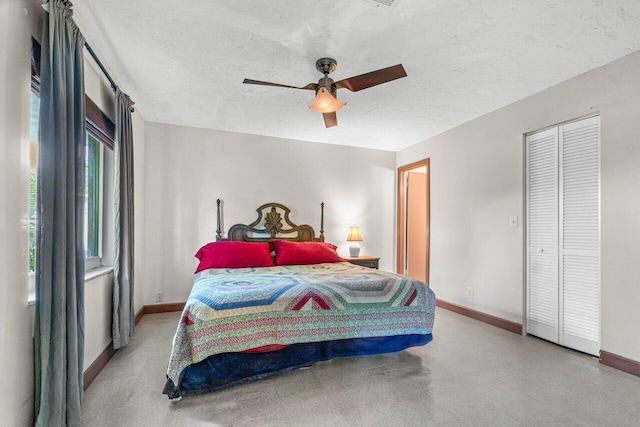 bedroom featuring ceiling fan, a closet, and a textured ceiling