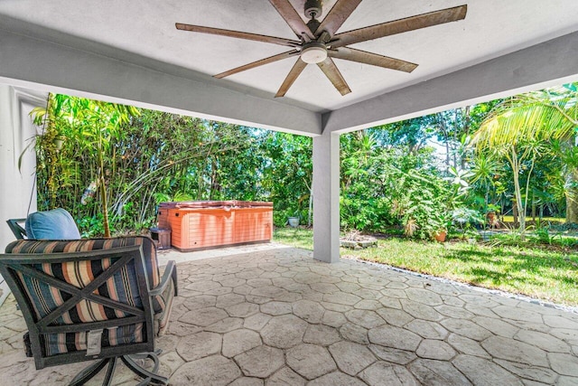 view of patio / terrace featuring ceiling fan and a hot tub