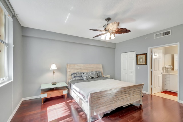 bedroom with wood finished floors, a ceiling fan, visible vents, baseboards, and a closet