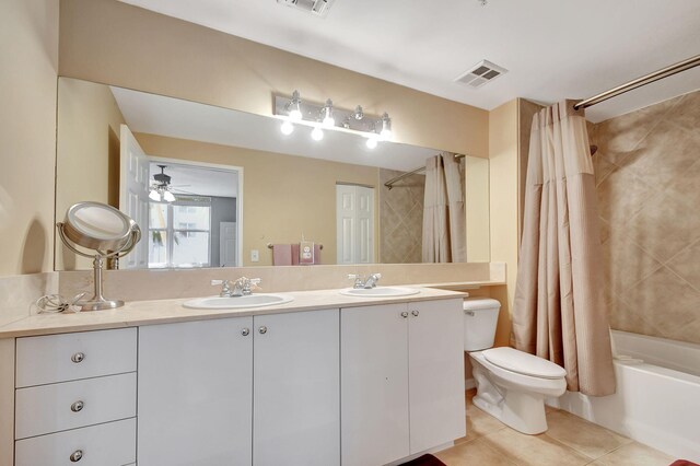 full bathroom with ceiling fan, shower / bathtub combination with curtain, tile patterned flooring, toilet, and vanity