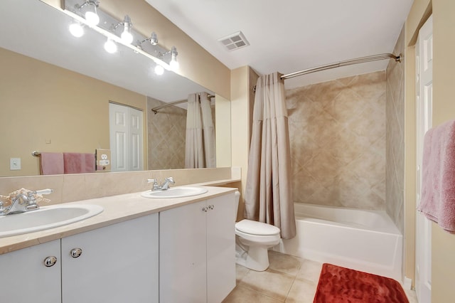 full bathroom featuring shower / tub combo with curtain, a sink, visible vents, and tile patterned floors