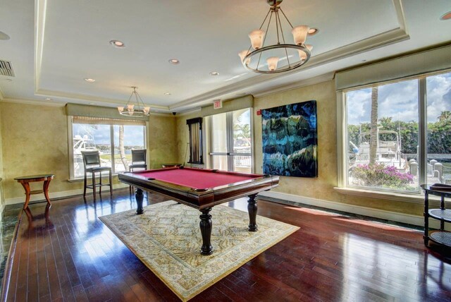 recreation room featuring dark hardwood / wood-style flooring, a tray ceiling, ornamental molding, and pool table