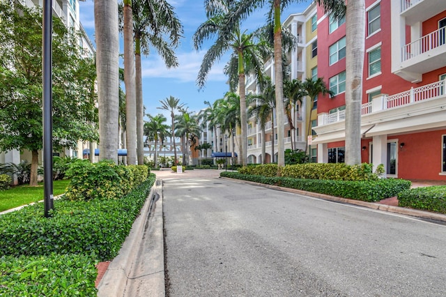 view of road with a residential view and curbs