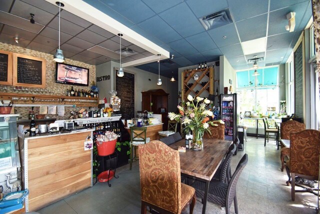 dining space featuring a drop ceiling