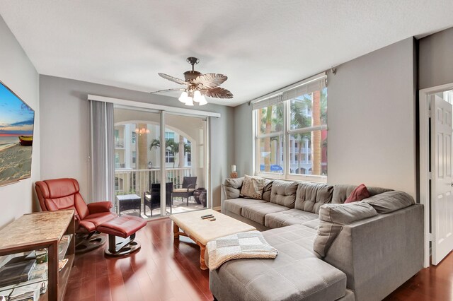 living room featuring ceiling fan and hardwood / wood-style floors