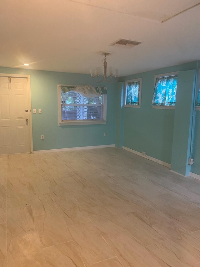 spare room featuring visible vents and baseboards