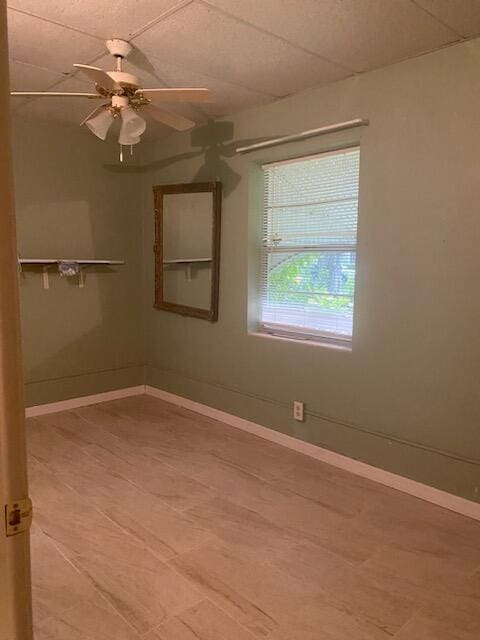 empty room featuring baseboards and a ceiling fan