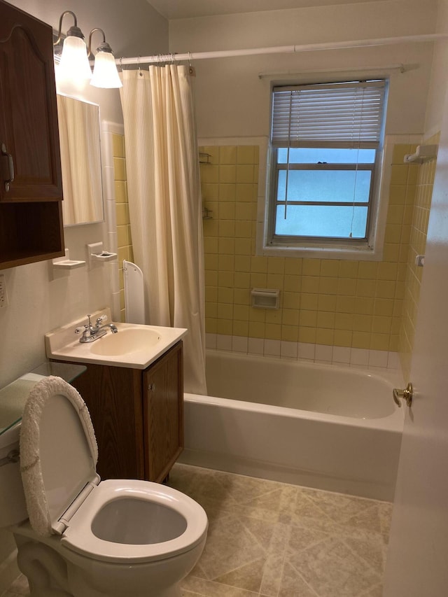 bathroom with toilet, tile patterned flooring, shower / tub combo with curtain, and vanity