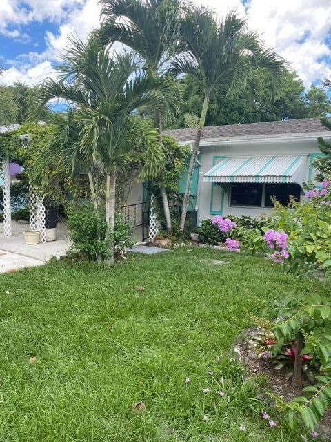 obstructed view of property featuring a front lawn