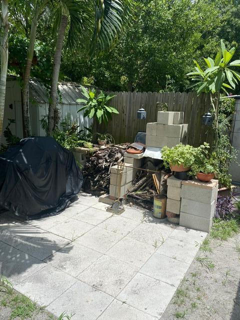 view of patio / terrace with a grill and fence