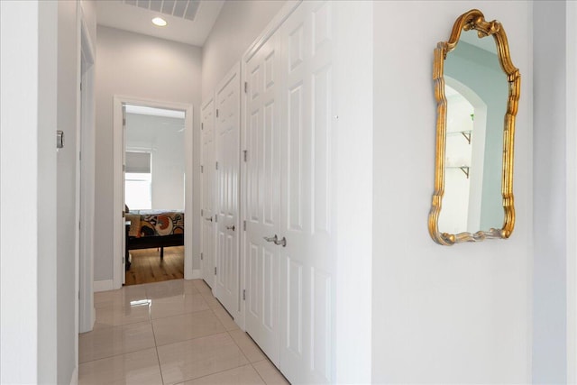 hallway featuring recessed lighting, visible vents, and light tile patterned flooring