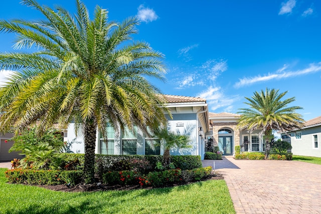 mediterranean / spanish-style house featuring a front lawn