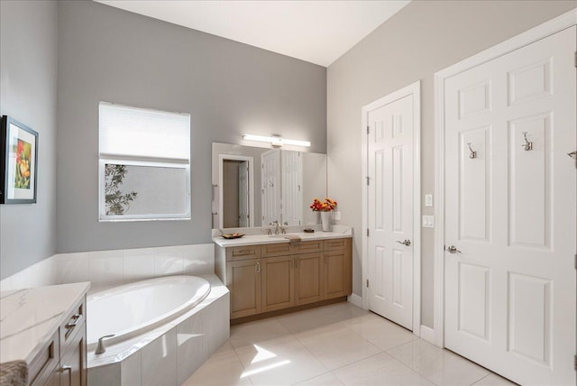 bathroom with tile patterned floors, vanity, and a bath