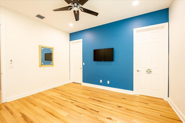 spare room with recessed lighting, visible vents, light wood-style flooring, a ceiling fan, and baseboards