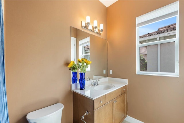 bathroom featuring toilet and vanity