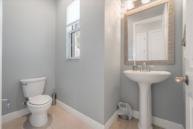 bathroom featuring baseboards, toilet, and tile patterned floors