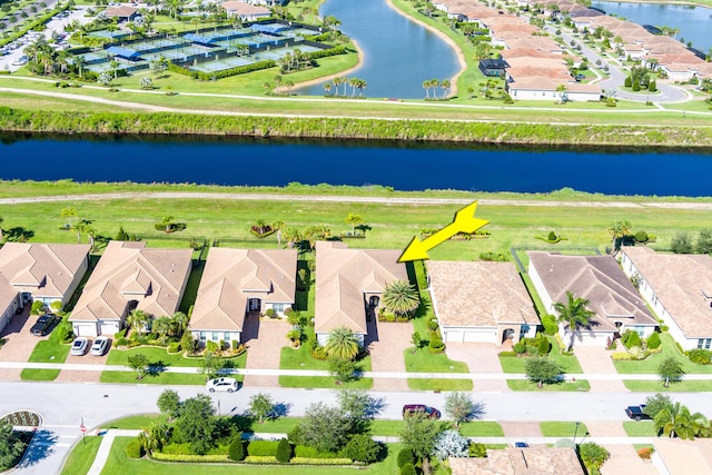 drone / aerial view with a water view and a residential view