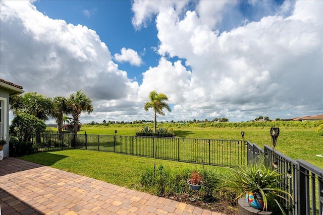 view of yard featuring a fenced backyard, a patio, and a rural view