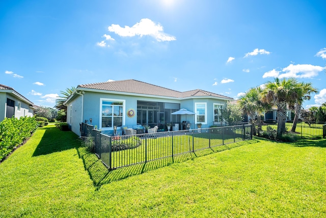 back of house featuring a patio, a fenced backyard, a tile roof, a lawn, and stucco siding