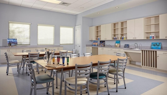 kitchen with a healthy amount of sunlight, visible vents, open shelves, and a drop ceiling