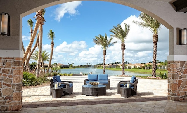 view of patio / terrace with a water view and outdoor lounge area