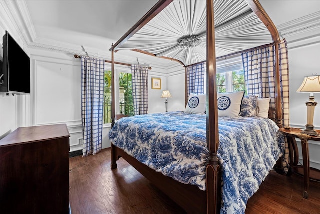 bedroom featuring ornamental molding and dark wood-style flooring